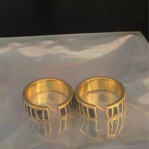 2 adjustable black and gold stackable rings
